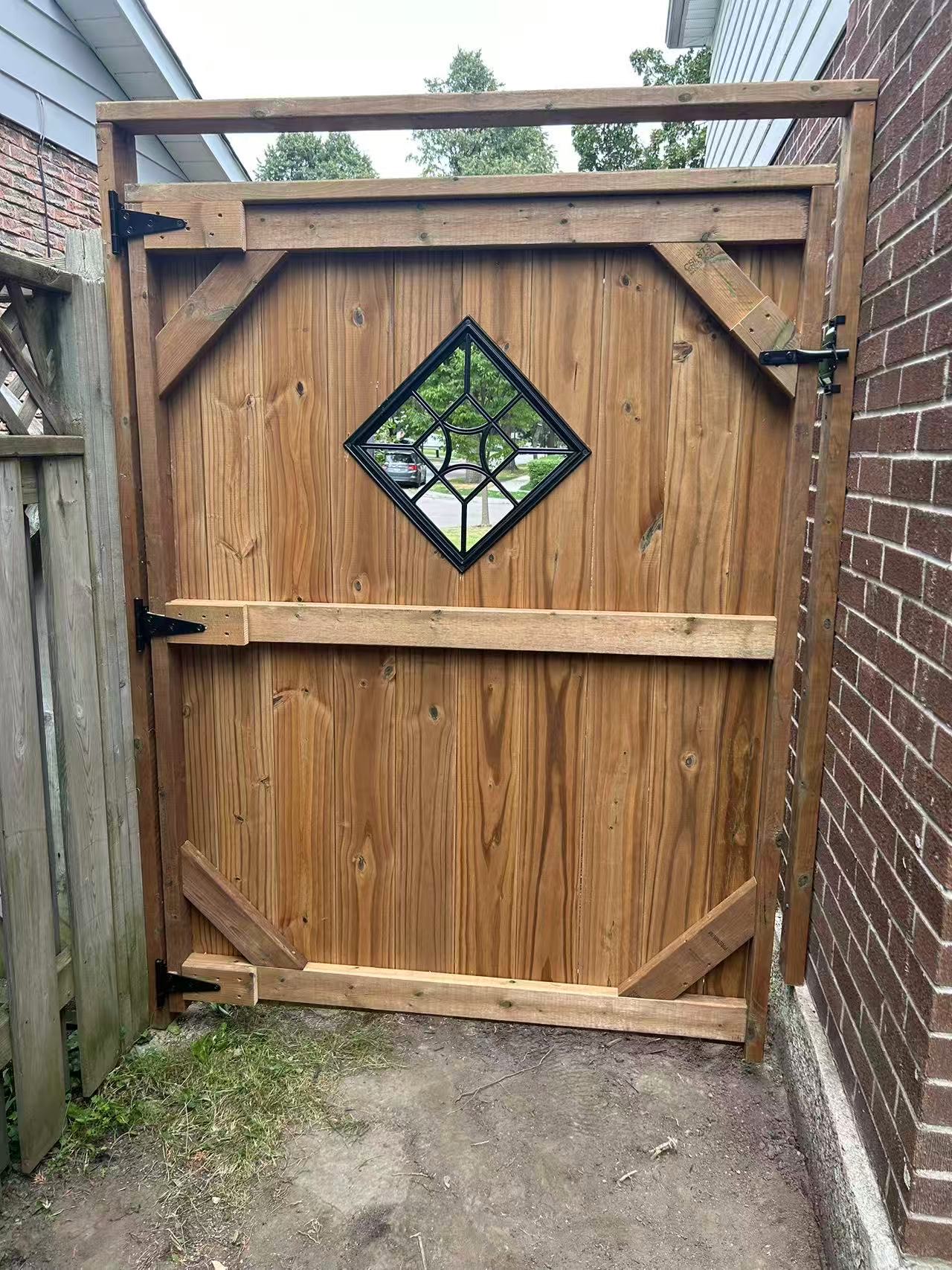 Custom cedar gate with diamond glass window insert and decorative corner bracing