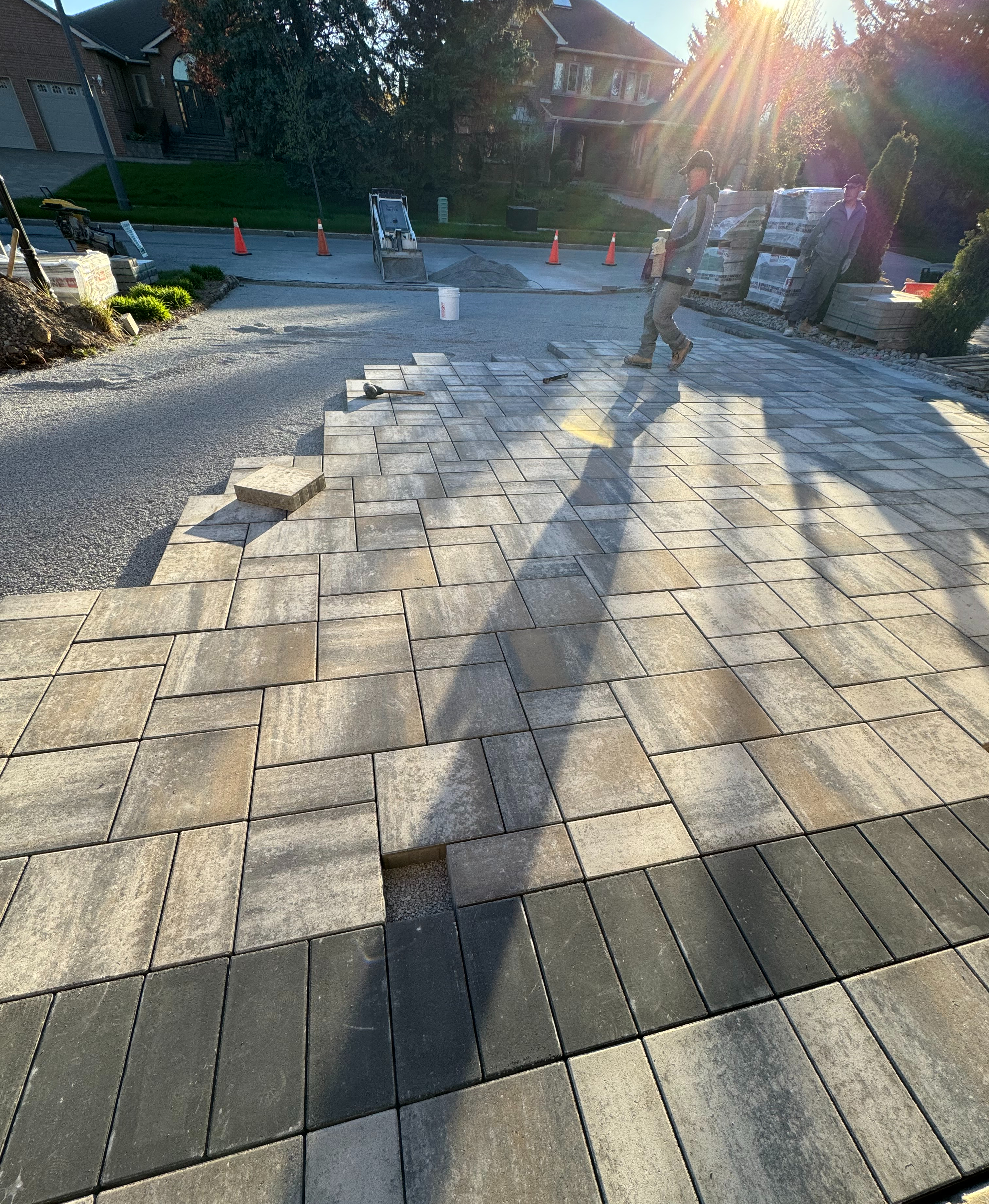 80mm interlock pavers being laid on driveway at golden hour
